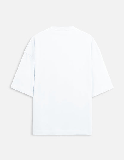 Color_White. versized unisex t-shirt featuring a centered, small graphic of the word "Aalasya" (laziness) written in red, stylized text with a red strikethrough line, signifying "No Laziness." Soft cotton, drop-shoulder, boxy casual apparel with ironic or statement typography.