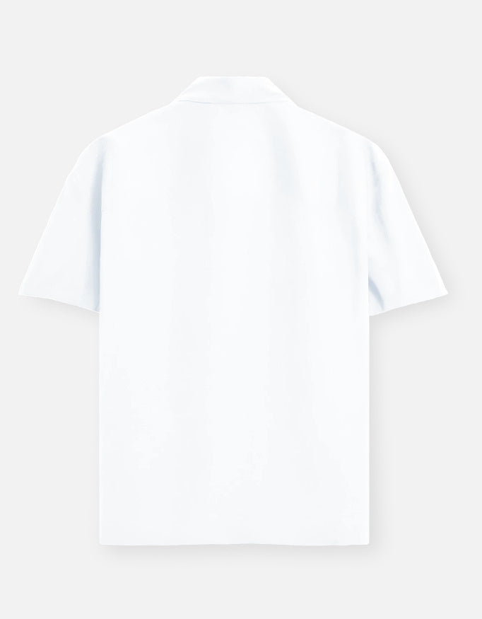Color_White. Premium unisex oversized button-down shirt with a wide, boxy fit and dropped shoulders. Made from breathable solid-colored cotton. Features a structured collar and longline hem, perfect for layered streetwear or minimalist smart-casual outfits.