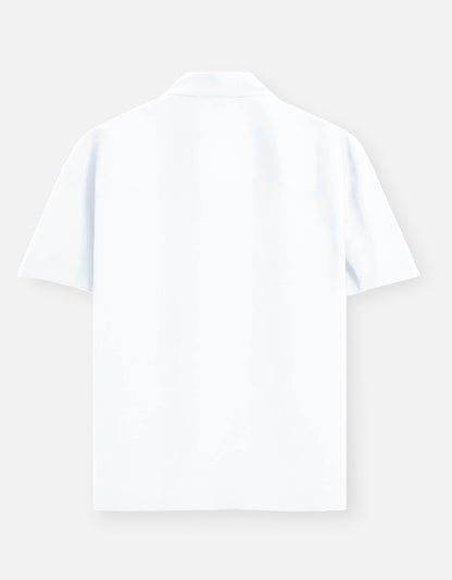 Color_White. Premium unisex oversized button-down shirt with a wide, boxy fit and dropped shoulders. Made from breathable solid-colored cotton. Features a structured collar and longline hem, perfect for layered streetwear or minimalist smart-casual outfits.