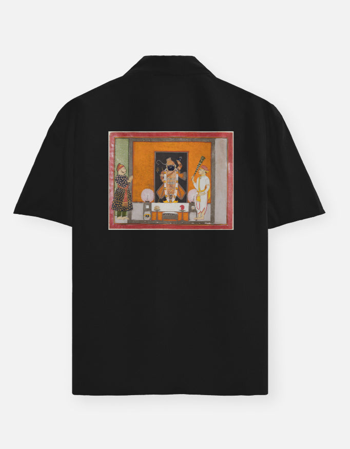 Color_Black. short-sleeve button-down shirt featuring a centered chest graphic of the Matsya avatar. Premium lightweight fabric with a camp collar and relaxed silhouette. Iconic heritage-inspired streetwear.