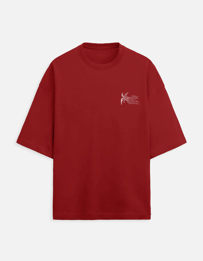 Color_Red. Oversized burgundy streetwear t-shirt featuring a small white phoenix graphic on the left chest. Features dropped shoulders, heavyweight cotton fabric, and a boxy fit.