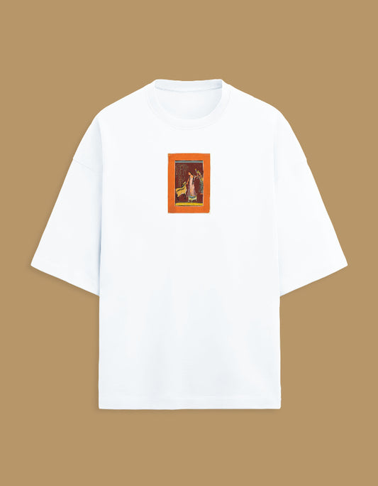 Color_White. Oversized white streetwear t-shirt featuring a centered rectangular graphic of a classical South Asian miniature painting with an orange border. Dropped shoulders, heavyweight cotton, boxy fit.