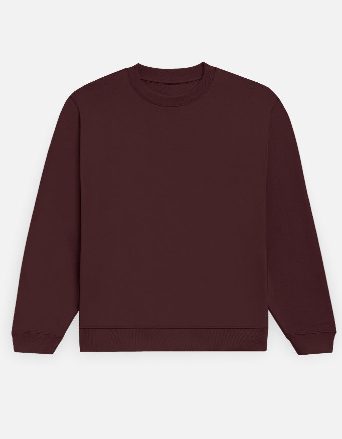 Color_Maroon. Premium solid-colored unisex crewneck sweatshirt made from 100% cotton and 300 GSM brushed fleece. Features a relaxed regular fit with snug ribbed cuffs and a structured hem. High-quality, heavyweight cozy apparel designed for cold weather and casual streetwear.