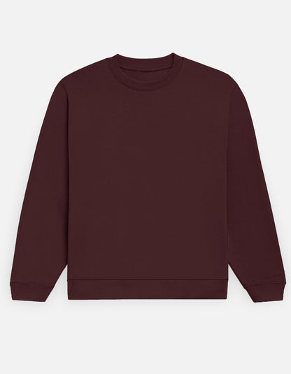 Color_Maroon. Premium solid-colored unisex crewneck sweatshirt made from 100% cotton and 300 GSM brushed fleece. Features a relaxed regular fit with snug ribbed cuffs and a structured hem. High-quality, heavyweight cozy apparel designed for cold weather and casual streetwear.