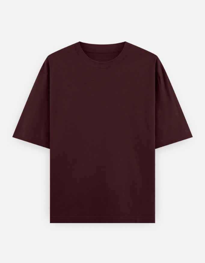 Color_Maroon. Oversized plain classic streetwear t-shirt in a premium heavyweight cotton blend. Features a boxy silhouette, dropped shoulders, and a clean, minimalist aesthetic without graphics.