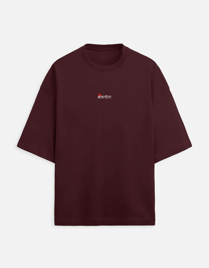 Deep maroon or burgundy oversized unisex t-shirt featuring a small, centered graphic of the Hindi text "भंडलोक" (Bhandlok - Wild/Drunk People) in light red, topped with a small red dot. Soft cotton, drop-shoulder, boxy casual apparel with a party-themed or humorous typographic design.