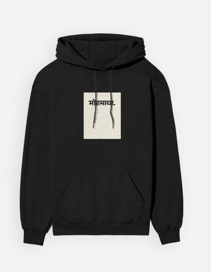 Color_Black. unisex heavyweight hoodie featuring a centered cream rectangular block with black "मोहमाया." (Mohmaya) Devanagari script. 300 GSM cotton brushed fleece with kangaroo pocket and ribbed finishes. Structured streetwear fit for cold weather.