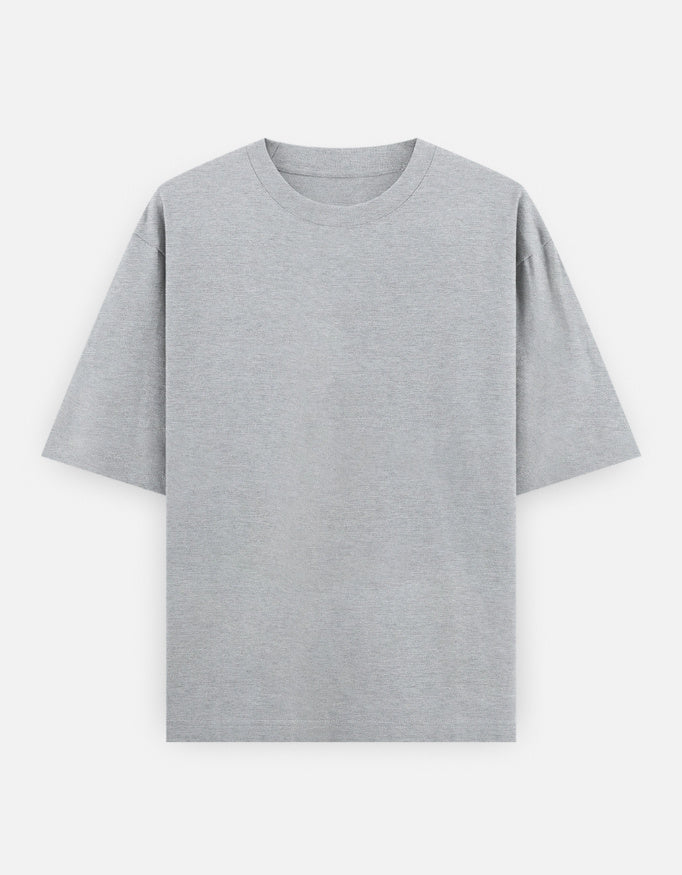 Color_GreyMelange. High-quality oversized unisex t-shirt with a classic crew neck and drop-shoulder construction. Smooth, heavy-weight cotton fabric in a solid color, offering a relaxed, boxy streetwear fit for a timeless aesthetic.