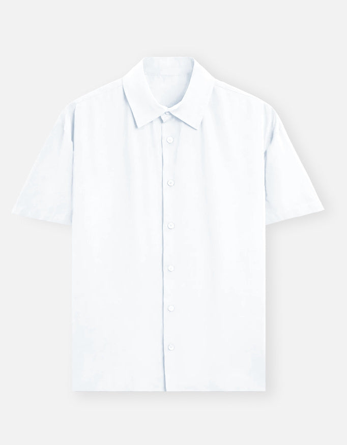 Color_White. Premium unisex oversized button-down shirt with a wide, boxy fit and dropped shoulders. Made from breathable solid-colored cotton. Features a structured collar and longline hem, perfect for layered streetwear or minimalist smart-casual outfits.