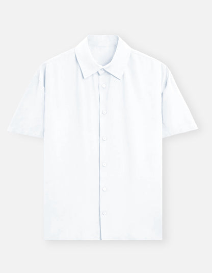 Color_White. Premium unisex oversized button-down shirt with a wide, boxy fit and dropped shoulders. Made from breathable solid-colored cotton. Features a structured collar and longline hem, perfect for layered streetwear or minimalist smart-casual outfits.