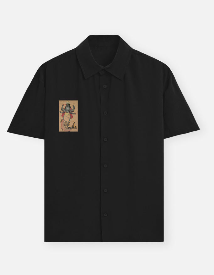 Color_Black. short-sleeve button-down shirt featuring a centered chest graphic of the Matsya avatar. Premium lightweight fabric with a camp collar and relaxed silhouette. Iconic heritage-inspired streetwear.